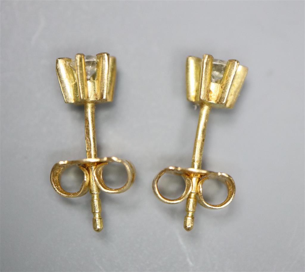 A small pair of modern 18ct gold and solitaire diamond earstuds, gross 1.4 grams.